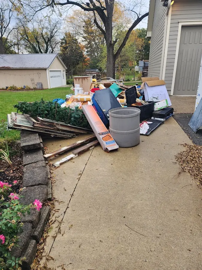 Dumpster being loaded with debris for 12 Yard Dumpster Rental in Marshfield